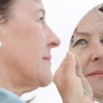 Mature Woman Examining Face