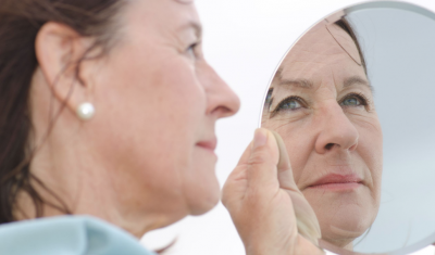 Mature Woman Examining Face