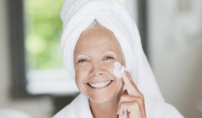 Older Woman Applying Moisturizer to Face
