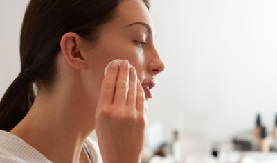 Woman Applying Toner to Face