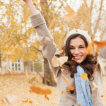 Woman Throwing Fall Leaves in Air