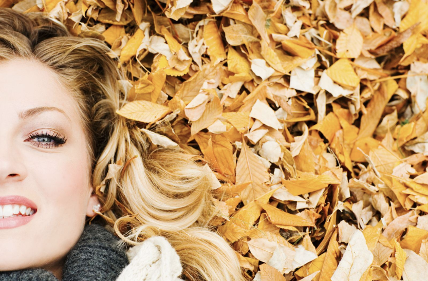Woman Laying on Fall Leaves